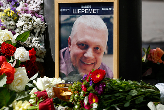 Flowers and a portrait of Pavel Sheremet mark the site of the journalist's murder in Kiev, July 20, 2016. (Sergei Chusavkov/AP)