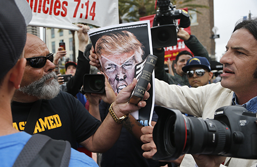 A confrontation outside a Trump rally in San Diego in May. Journalists covering the Republican and Democratic conventions are advised to take security precautions. (AP/Lenny Ignelzi)