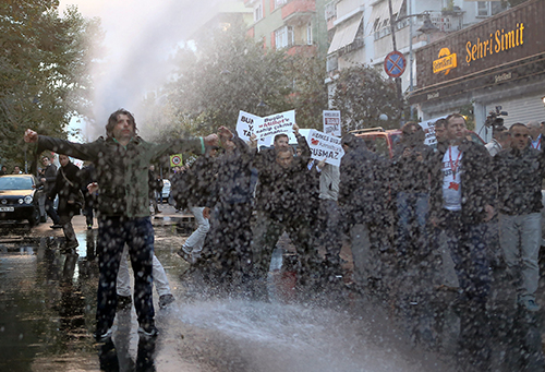 Riot police use water cannons on crowds protesting the takeover of the Koza-İpek Media group in October 2015. An arrest warrant was issued this week for Tarık Toros, a former journalist at the group. (AP/Mehmet Ali Poyraz, Cihan News Agency)