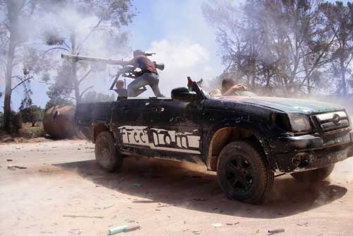 This June 20, 2011, photo by Abdelqadir Fassouk shows rebel fighters firing a rocket toward pro-Qaddafi forces on the front line in Misrata, Libya. Fassouk was killed on July 22, 2016, while covering clashes between government-allied forces and the militant group Islamic State. (AP/Abdelqadir Fassouk)