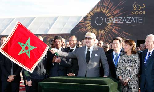 King Mohammed VI waves a Moroccan flag as he inaugurates a solar plant in Ouarzazate, central Morocco, on February 4, 2016. The king and national symbols like the flag are sensitive subjects for the media. (AP/Abdeljalil Bounhar)