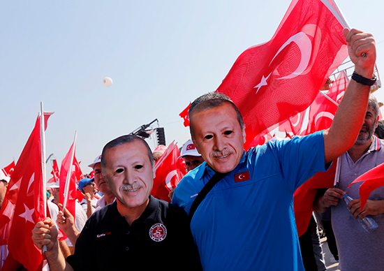 Participants in an August 7, 2016, pro-government rally in Istanbul wear masks depicting Turkish President Recep Tayyip Erdoğan (Reuters/Umit Bektas)