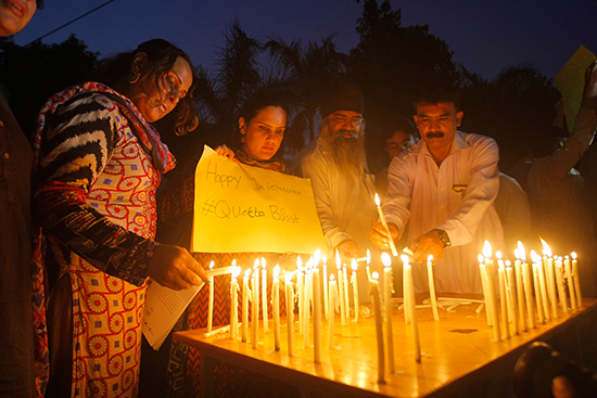 Civil society activists in Peshawar pay tribute to the victims of a bomb attack on mourners at a hospital in Quetta, August 8, 2016. At least two journalists were killed in the blast. (AP/Mohammad Sajjad)