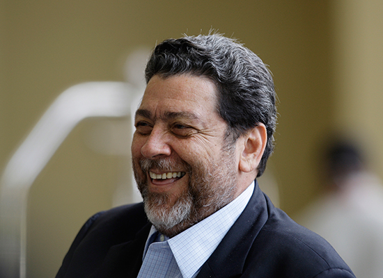 Vincentian Prime Minister Ralph Gonsalves, pictured on a 2009 visit to Trinidad, has defended criminal defamation laws as preserving "peace and tranquility." (AP/Andres Leighton)