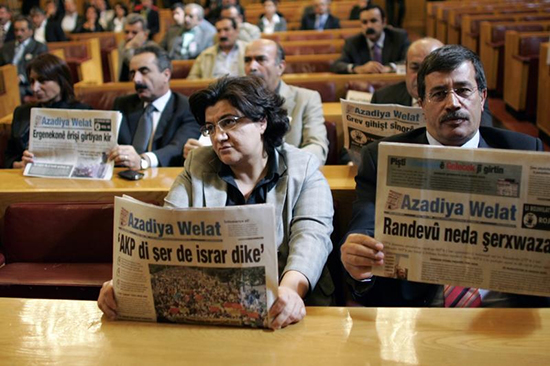 In this October 2008 file photo, opposition lawmakers hold copies of Azadiya Welat newspaper during a meeting of the parliament to protest a month-long ban on the publication. (Umit Bektas/Reuters)