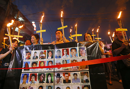 Relatives of the journalists killed in the Maguindanao massacre hold a vigil in 2015. A new task force has been set up to investigate press killings. (AP/Bullit Marquez)