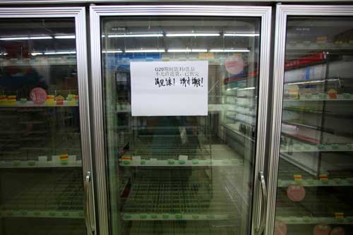 An empty refrigerator at a convenience store at West Lake, in Hangzhou, China, on August 31 bears a sign that reads 'During G20, beverages and dairy products are not allowed to be purchased and are sold out. Thanks.' Authorities have ordered the media not to report on inconveniences caused by the summit. (Reuters/Aly Song)
