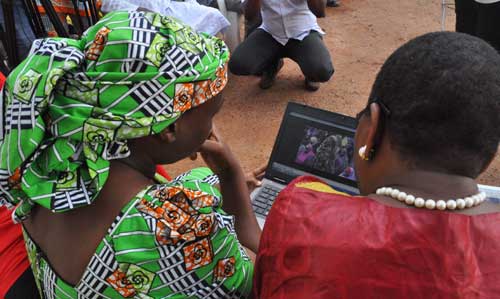 Esther Yakubu, left, mother of one of hundreds of kidnapped school girls, watches a video released by Boko Haram during a briefing in Abuja, Nigeria, on August 14, 2016. A military spokesman threatened journalist Ahmad Salkida with terrorism charges if he does not provide information he gained in the course of reporting on the militant group. (AP Photo/Olamikan Gbemiga)