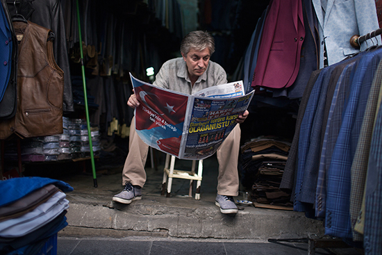 In this July 21, 2016, file photo, a merchant reads the newspaper in Istanbul. (AP/Petros Giannakouris)