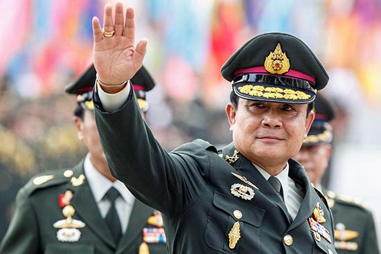 In this September 30, 2014, file photo, Thai Prime Minister Prayut Chan-o-cha waves after a Bangkok handover ceremony for the new chief of the Royal Thai Army. (Reuters/Athit Perawongmetha)