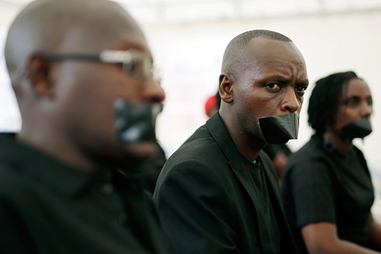 Burundian journalists mark World Press Freedom day, May 3, 2015, by taping their mouths shut to protest worsening conditions for the press in Bujumbura. (AP/Jerome Delay)