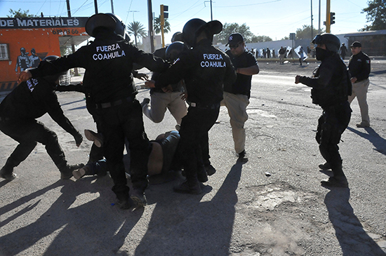 Police beat a demonstrator in Monclova, in Mexico's Coahuila state, at a protest against rising fuel prices, January 5, 2017. (Fidencio Alonso/Courtesy of Zocalo de Monclova, via Reuters)