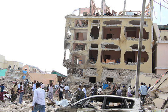 Somalis gather at the site of a Mogadishu hotel badly damaged in a lethal attack on January 25, 2017. (AP/Farah Abdi Warsameh)