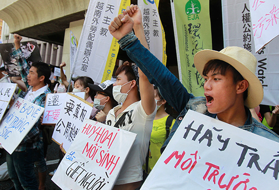 Vietnamese environmental activists protest an industrial accident that caused tons of fish to wash up on Vietnamese shores at an August 10, 2016, demonstration in Taipei, Taiwan. Detained videographer Nguyen Van Hoa published online videos of similar protests in Vietnam. (AP/Chiang Ying-ying)