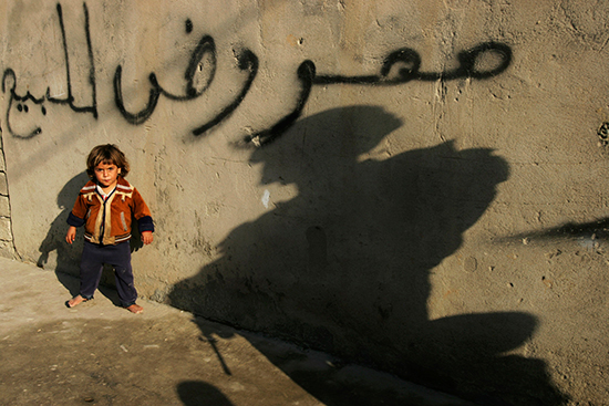 A child looks at a U.S. soldier in Mosul, November 17, 2008 (AP/Petros Giannakouris)