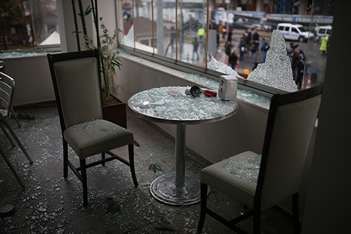 Broken glass scatters across the inside of a café close to the Izmir courthouse targeted in a bombing. News outlets have been ordered to report only official statements about the attack. (STR/AFP)