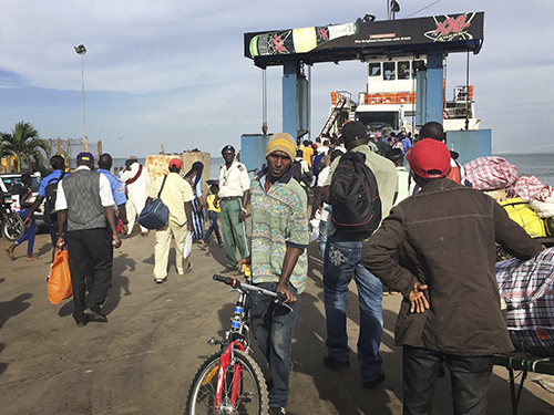 People board a ferry leaving Banjul in Gambia on January 18, amid the threat of military intervention after President Yahya Jammeh refused to concede defeat in elections. Gambia has denied entry to several journalists planning to cover the January 19 inauguration of Adama Barrow. (AP)