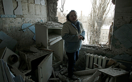 A woman stands in the rubble of her apartment, which was damaged by shelling, in the eastern Ukrainian city of Donetsk, February 1, 2017. (Reuters/Alexander Ermochenko)