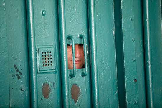A guard looks through a small window in Algiers' El Harrach Prison, July 14, 2010. (Reuters/Louafi Larbi)