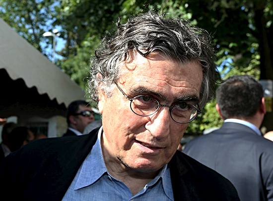 A court on February 14, 2017, handed columnist Hasan Cemal, seen here at a colleague's funeral in Istanbul on October 30, 2015, a suspended sentence of one year and three months in prison on charges of propagandizing for a terrorist group in one of his columns.