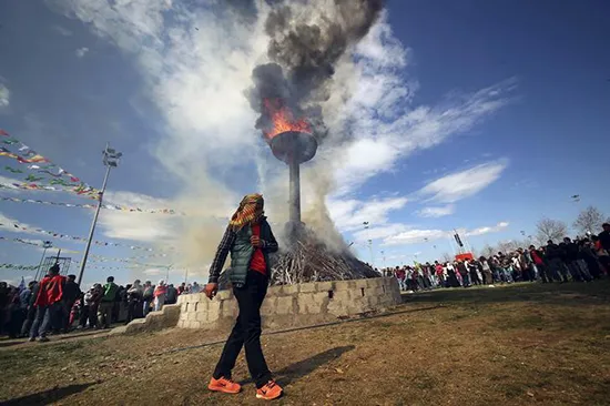 A demonstrator walks around a bonfire to mark the spring festival of Newroz in the southeastern Turkish city of Diyarbakır, March 21, 2016. Ethnic Kurds marked the occasion last year with a demonstration calling for the resumption of peace talks with the government. (Reuters/Sertac Kayar)