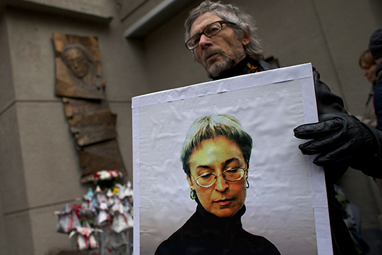 A man holds a photograph of murdered Novaya Gazeta investigative reporter Anna Politkovskaya outside the newspaper's Moscow office on October 7, 2014, the eighth anniversary of her death. Politkovskaya was known for her work exposing human rights abuses in Chechnya and the North Caucasus region. (AP/Ivan Sekretarev)