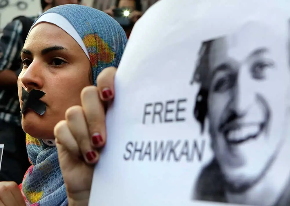 A protest against the jailing of photojournalist Mahmoud Abou Zeid, known as Shawkan, in front of the Journalists' Syndicate in Cairo on July 12, 2014. Egypt has sought to silence its critics in recent years. (AP/Amr Nabil)
