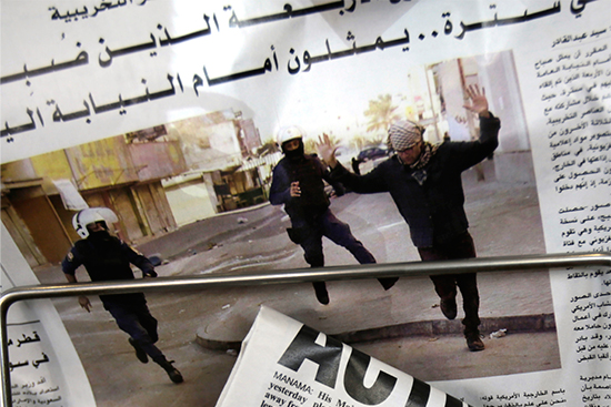 Bahraini newspapers feature front-page stories on the arrest of four American journalists, with one photo purportedly showing one of the journalists with hands raised while being arrested, in Manama, Bahrain, February 16, 2016. The journalists were quickly released. (AP/Hasan Jamali)