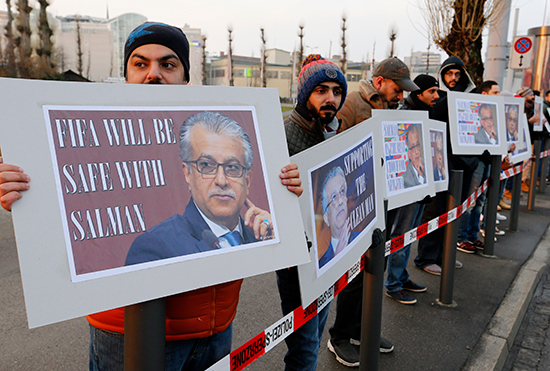 Supporters of Bahraini Sheikh Salman bin Ebrahim Al-Khalifa hold signs reading "Supporting the clean man" and "FIFA will be safe with Salman" in Zurich, Switzerland, February 26, 2016. (AP/Michael Probst)