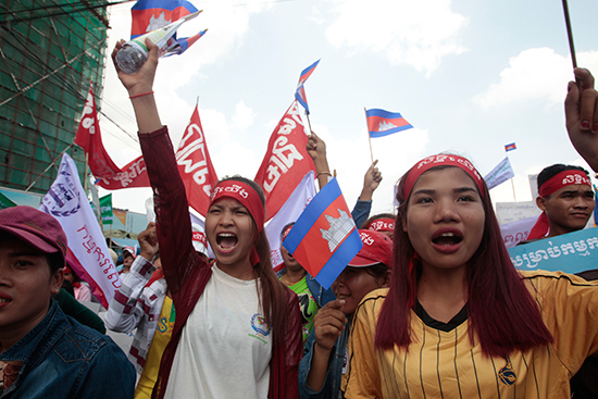 Garment workers protest for higher wages near Cambodia's National Assembly in Phnom Penh, May 1, 2017. As the government clamps down on opposition ahead of local elections scheduled for June, a Radio Free Asia journalist has fled the country upon learning of a court summons. (AP/Heng Sinith)