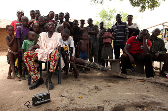 In this May 10, 2016, file photo, residents of the rural Nigerian village Agatu listen to a radio news broadcast. (AFP/Getty/Emmanuel Arewa)