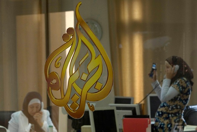 In this 2009 file photo, Palestinian journalists work in the Ramallah office of Qatari broadcaster Al-Jazeera. Saudi Arabia, the United Arab Emirates, and Bahrain blocked access to Al-Jazeera's websites on May 24, 2017. (Reuters/Fadi Arouri)