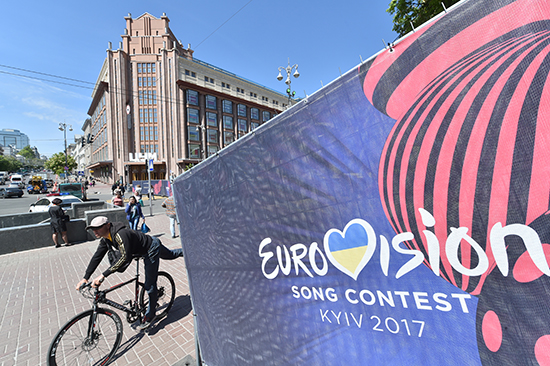 A cyclist passes a poster in Kiev for the Eurovision song content. Ukraine expelled three Russian journalists who traveled to Kiev for the annual event. (AFP/Sergei Supinsky)