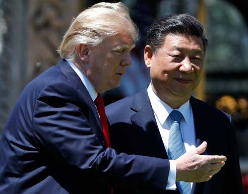 U.S. President Donald Trump and Chinese President Xi Jinping walk together after their meetings at Mar-a-Lago in Palm Beach, Florida, on April 7, 2017. (AP/Alex Brandon)