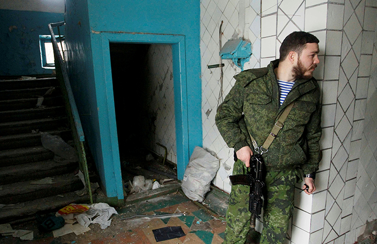 A pro-Russian separatist inspects a building damaged in fighting with Ukrainian security forces in Donetsk, eastern Ukraine, on February 23, 2017. (Reuters/Alexander Ermochenko)