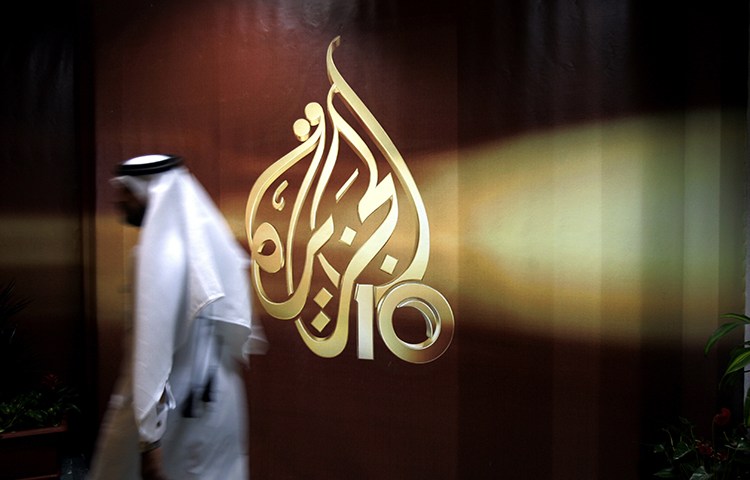 A Qatari employee of Al-Jazeera walks into its Doha headquarters in this 2006 file photo (AP/Kamran Jebreili)