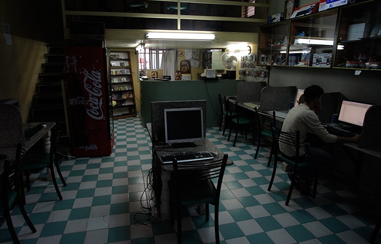In this November 2010 file photo, a man uses a computer in an internet cafe in the West Bank town of Bethlehem (AP/Nasser Shiyoukhi)