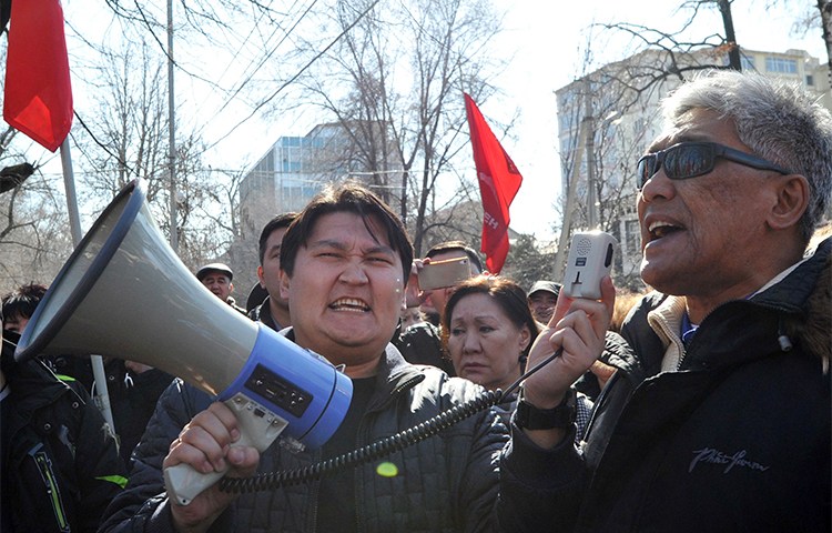 Supporters of detained opposition politician Omurbek Tekebayev protest in the Kyrgyzstan's capital Bishkek, in February. A media group that reported on comments by Tekebayev is facing five separate charges of insulting the president. (AFP/Vyacheslav Oseledko)