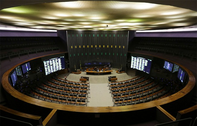 Brazil's Chamber of Deputies holds a session on April 12 with only two deputies after the Supreme Court announced corruption investigations into a number of politicians. A journalist has questioned why the court released details of his telephone call with a source, despite him not being part of the investigation. (AP/Eraldo Peres)