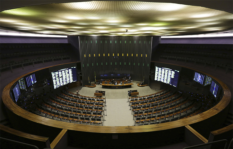Brazil's Chamber of Deputies holds a session on April 12 with only two deputies after the Supreme Court announced corruption investigations into a number of politicians. A journalist has questioned why the court released details of his telephone call with a source, despite him not being part of the investigation. (AP/Eraldo Peres)