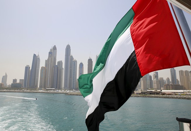 In this May 22, 2015, file photo, the flag of the United Arab Emirates flies over a boat in the Dubai Marina. (Reuters/Ahmed Jadallah)