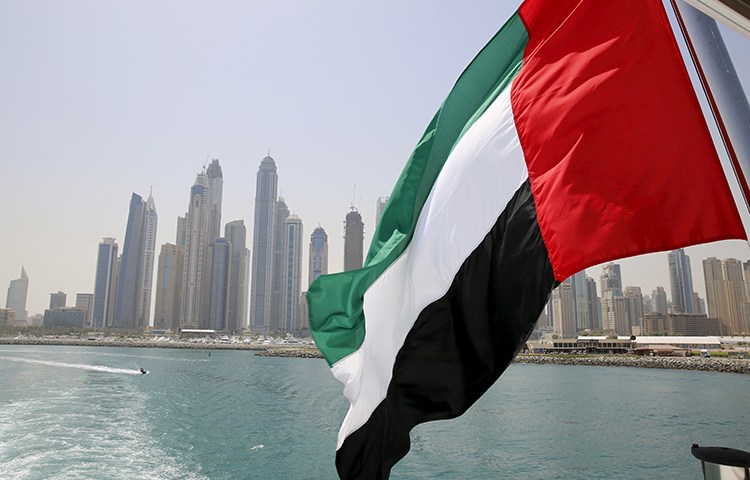 In this May 22, 2015, file photo, the flag of the United Arab Emirates flies over a boat in the Dubai Marina. (Reuters/Ahmed Jadallah)