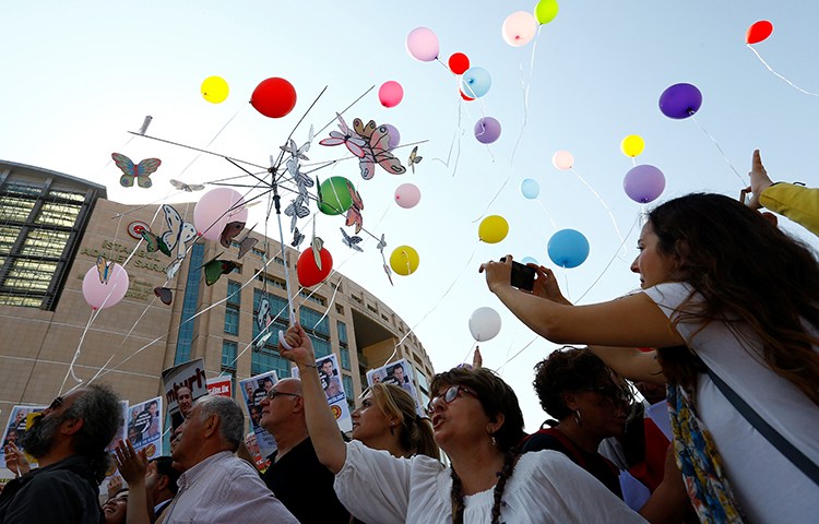 Journalists and press freedom advocates release balloons in front of the courthouse in Istanbul where 17 journalists and board members from Cumhuriyet newspaper were standing trial, July 24, 2017. (Reuters/Murad Sezer)