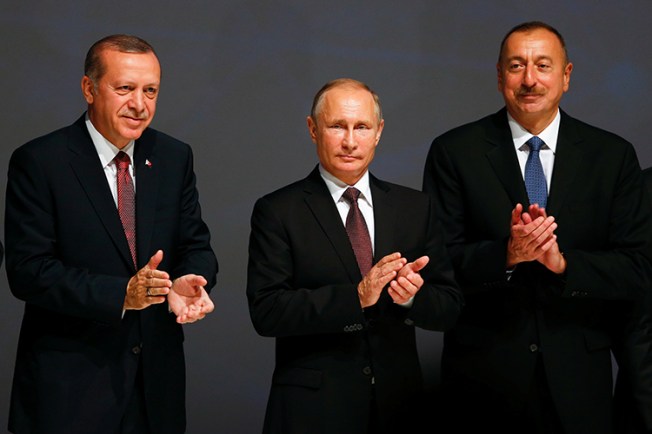 Azerbaijani President Ilham Aliyev (right) stands with Turkish President Recep Tayyip Erdoğan (left), and Russian President Vladimir Putin at an energy summit in Istanbul, October 10, 2016. (Reuters/Murad Sezer)