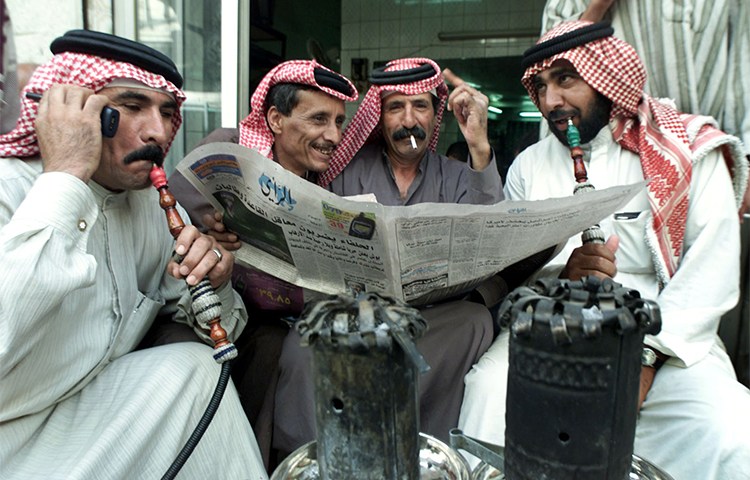 In this 2001 file photo, Jordanian men read a newspaper in a cafe in Amman. (Reuters/Ali Jarekji)