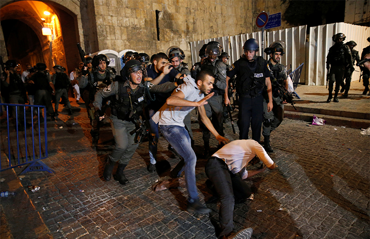 Israeli police and Palestinians clash outside the Lion's Gate of Jerusalem's Old City on July 18. At least two journalists were injured while covering the protests. (Reuters/Ammar Awad)