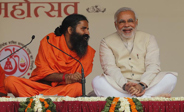 Narendra Modi, then prime ministerial candidate for India's Bharatiya Janata Party, shares a moment with guru Baba Ramdev (left) in New Delhi, March 23, 2014. (Reuters/Adnan Abidi)