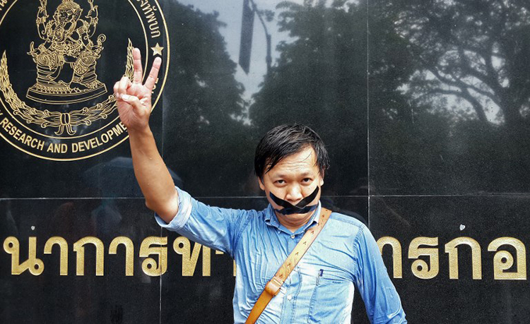 Pravit Rojanaphruk stands outside the Bangkok military base where he had been summoned on May 25, 2014. (AFP)