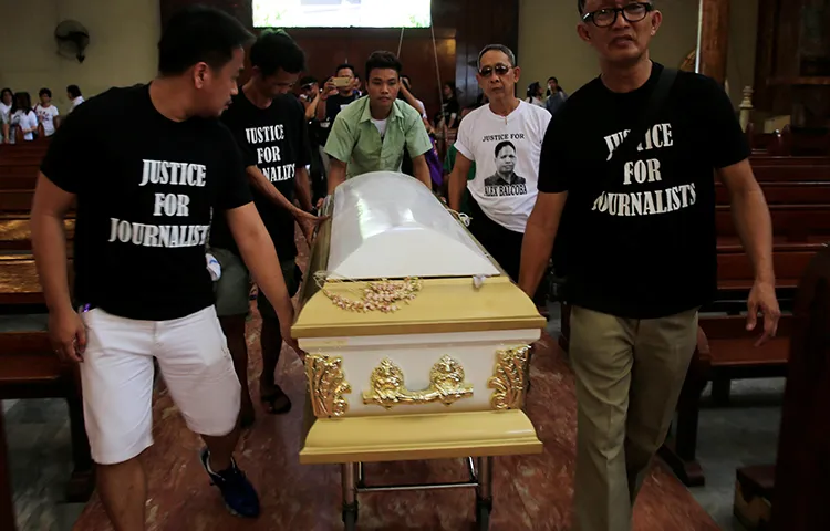 The Philippines ranks fourth on CPJ's most recent global Impunity Index, a measure of countries where journalists are killed and their murderers go free. Here, Filipino journalists escort the coffin of slain news reporter Alex Balcoba during his funeral in Manila, June 1, 2016. (Reuters/Romeo Ranoco)