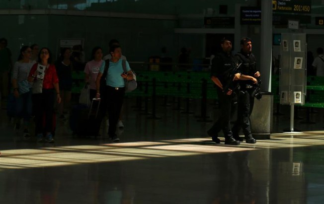 Police patrol Barcelona-El Prat airport on June 13, 2017. (Reuters/Albert Gea)